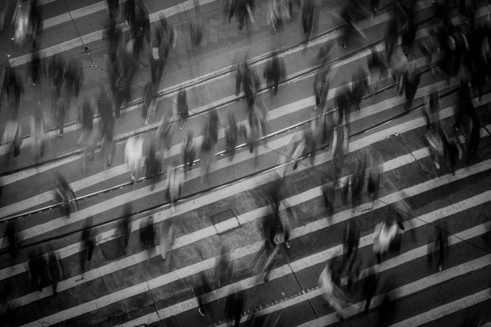 time lapse photo of people walking on pedestrian lane