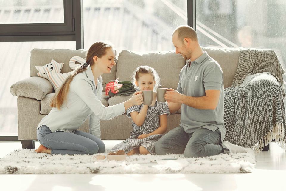 family holding mugs